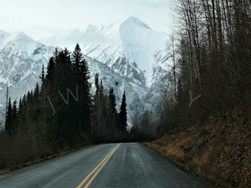 The snow encrusted mountains in the background of the Stewart-Cassiar highway to the Yukon