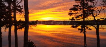 A Mirror November sunset of orange, yellow and purple on the bay in Newfoundland