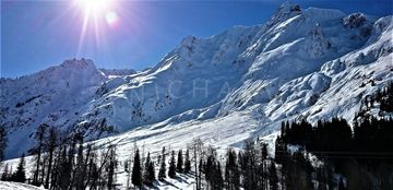 The winter sun highlights the shadows on the snow in the mountains of highway 37A