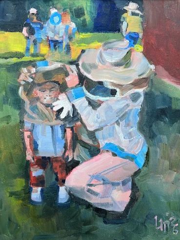 Beekeeping woman adjusting the veil for a child beekeeper