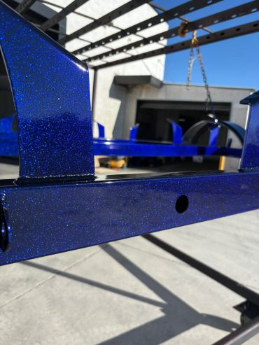 Close-up of a glossy blue metal frame with sparkles.