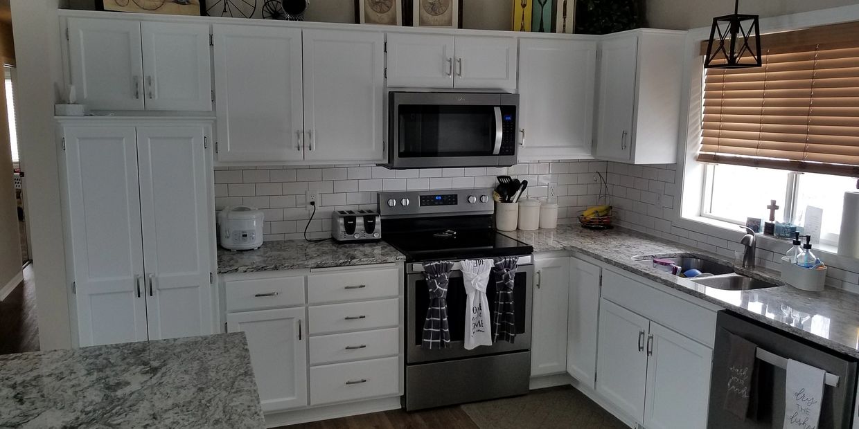 Remodeled Kitchen Room With Cream Cabinets, Black Appliances And White  Walls. Northwest, USA Stock Photo, Picture and Royalty Free Image. Image  97021825.