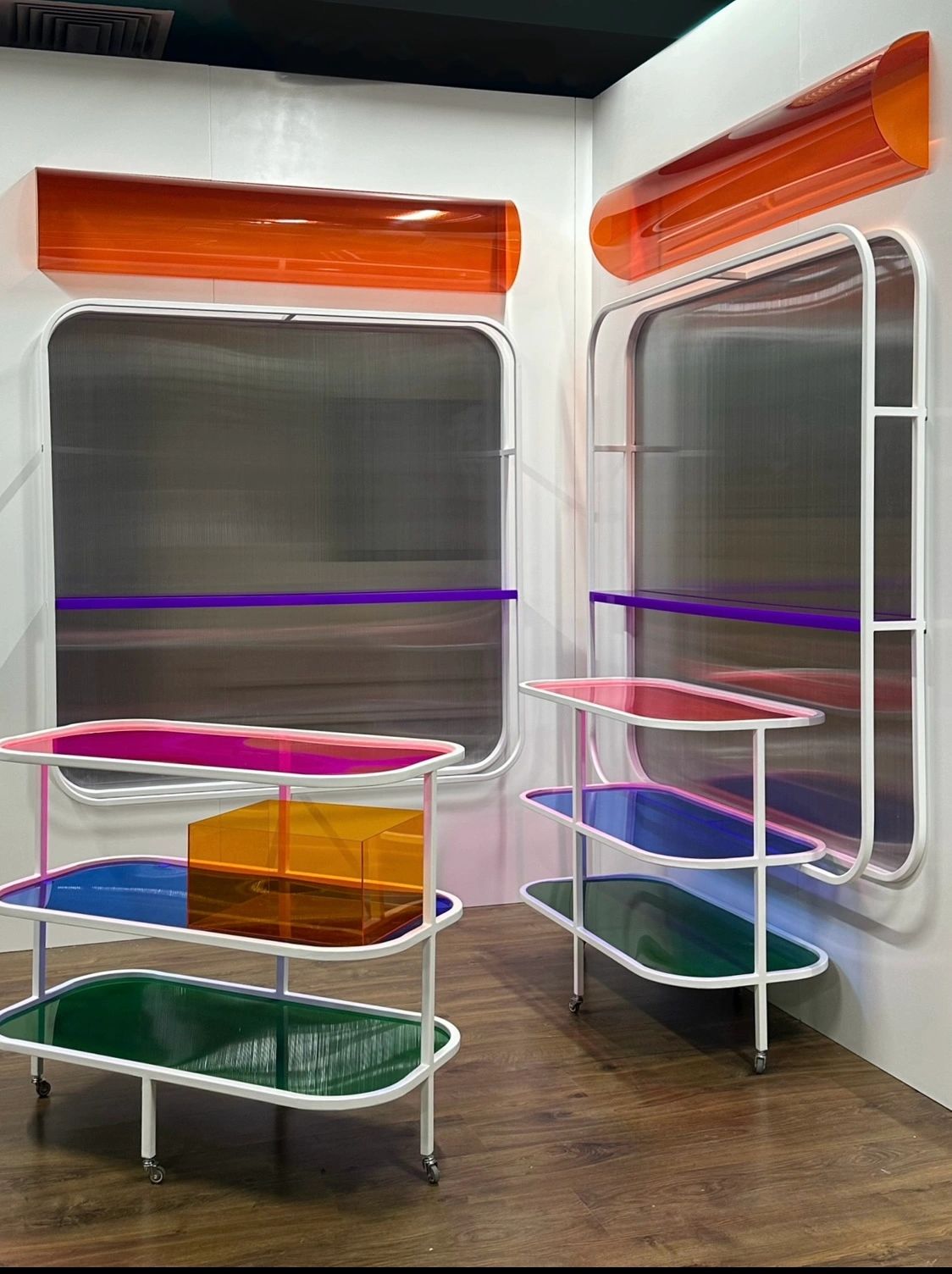 Colorful modern furniture with translucent panels and white frames in a minimalist room.