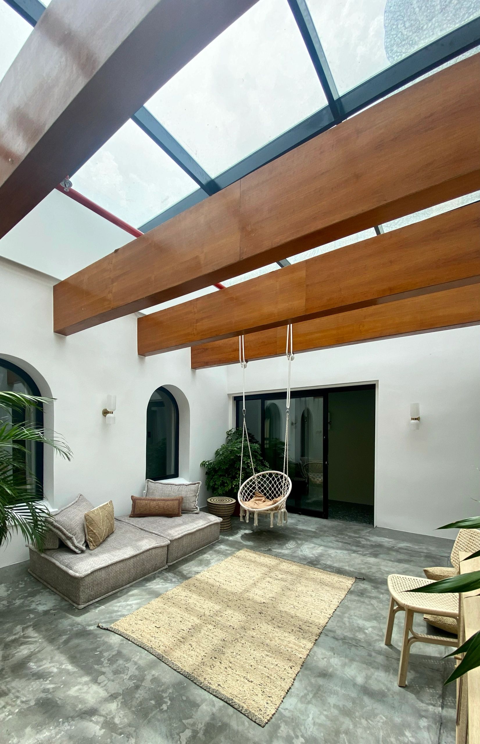 Modern indoor patio with natural light and seating.