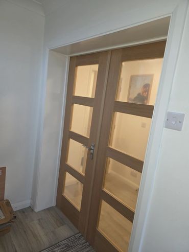 Wooden door with glass panels in a modern interior.