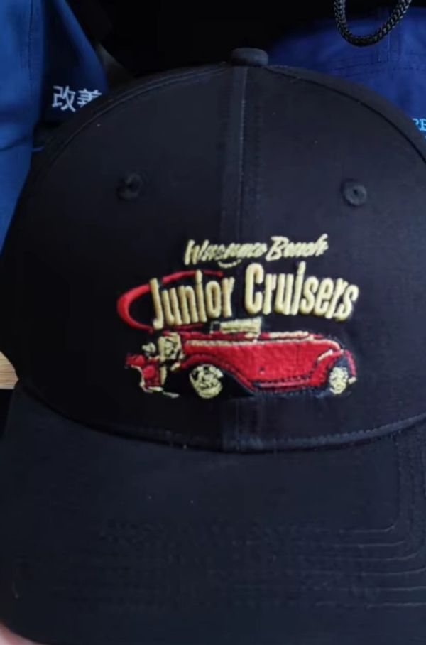 Black cap with embroidery of a red vintage car and 'Junior Cruisers' text.