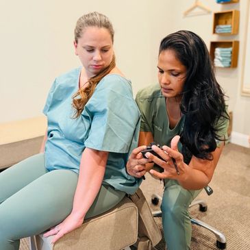 Dr. Ayesha is demonstrating the use of a thermal meter to detect nerve dysfunctions to a female pati
