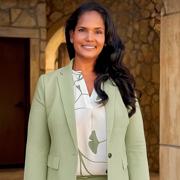 Professional portrait of Dr. Ayesha wearing a suit