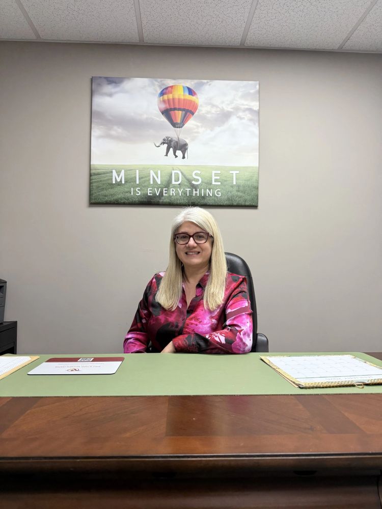 Ileana Asanache at her desk at Body and Mind Wellness Center in Lynchburg, Virginia.