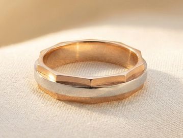 14k two tone yellow and white gold carved geometric faceted wedding band with brushed white gold