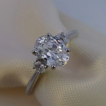 14K white gold engagement ring with 1.25ct oval center and 0.11ctw oval side stones