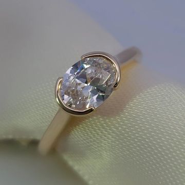 14K yellow gold engagement ring with a 1.75ct oval diamond in a bezel setting