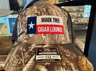 Camo cap with Texas flag and "Shade Tree Cigar Lounge" patch on the front.
