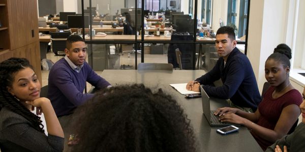 Group of diverse people having a meeting around a table.