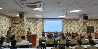 Military personnel in a classroom setting with a presentation.