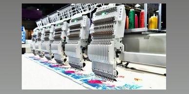 Industrial embroidery machine working on fabric.