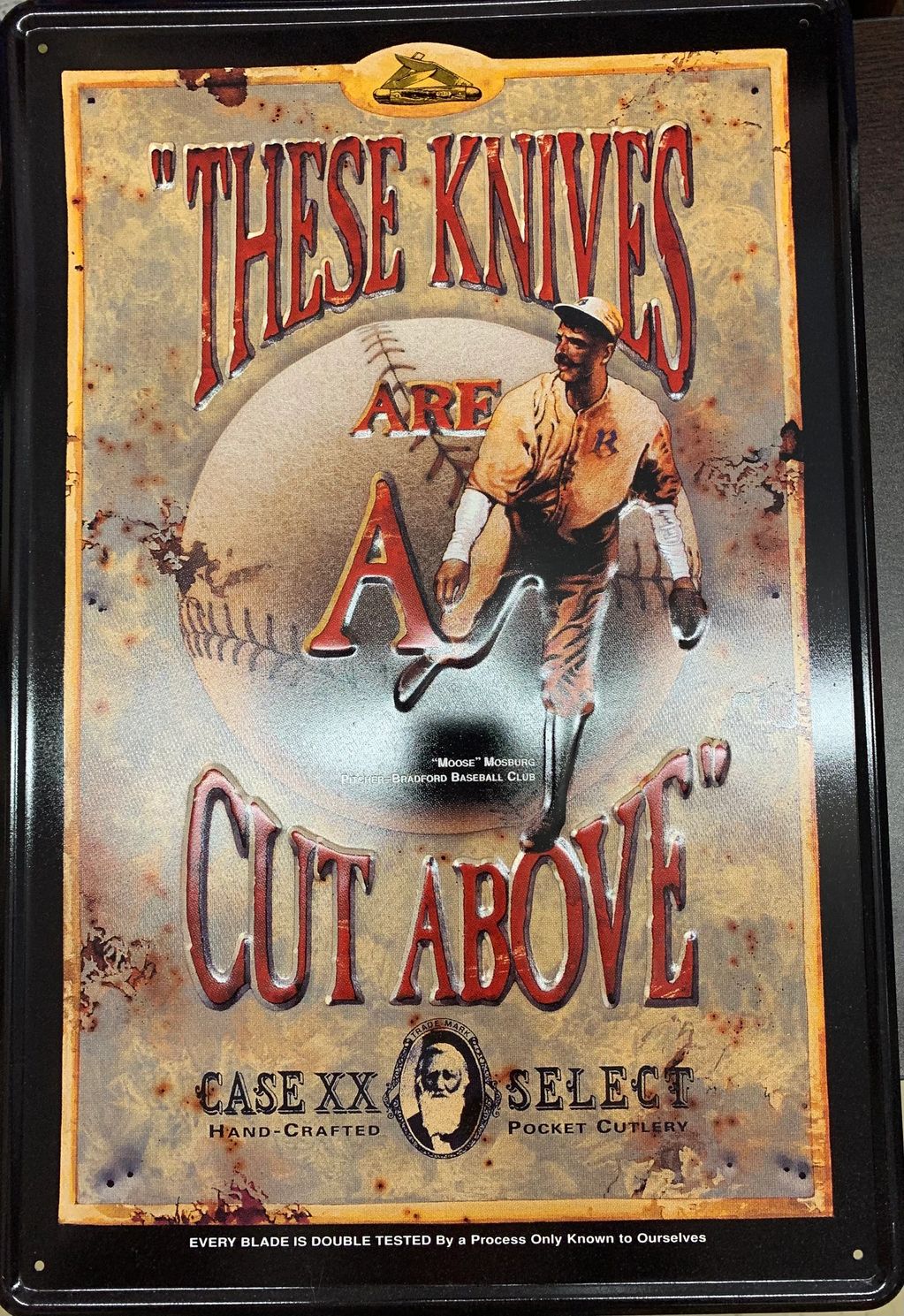 Case metal "THESE KNIVES ARE A CUT ABOVE" sign with Moose Mossberg