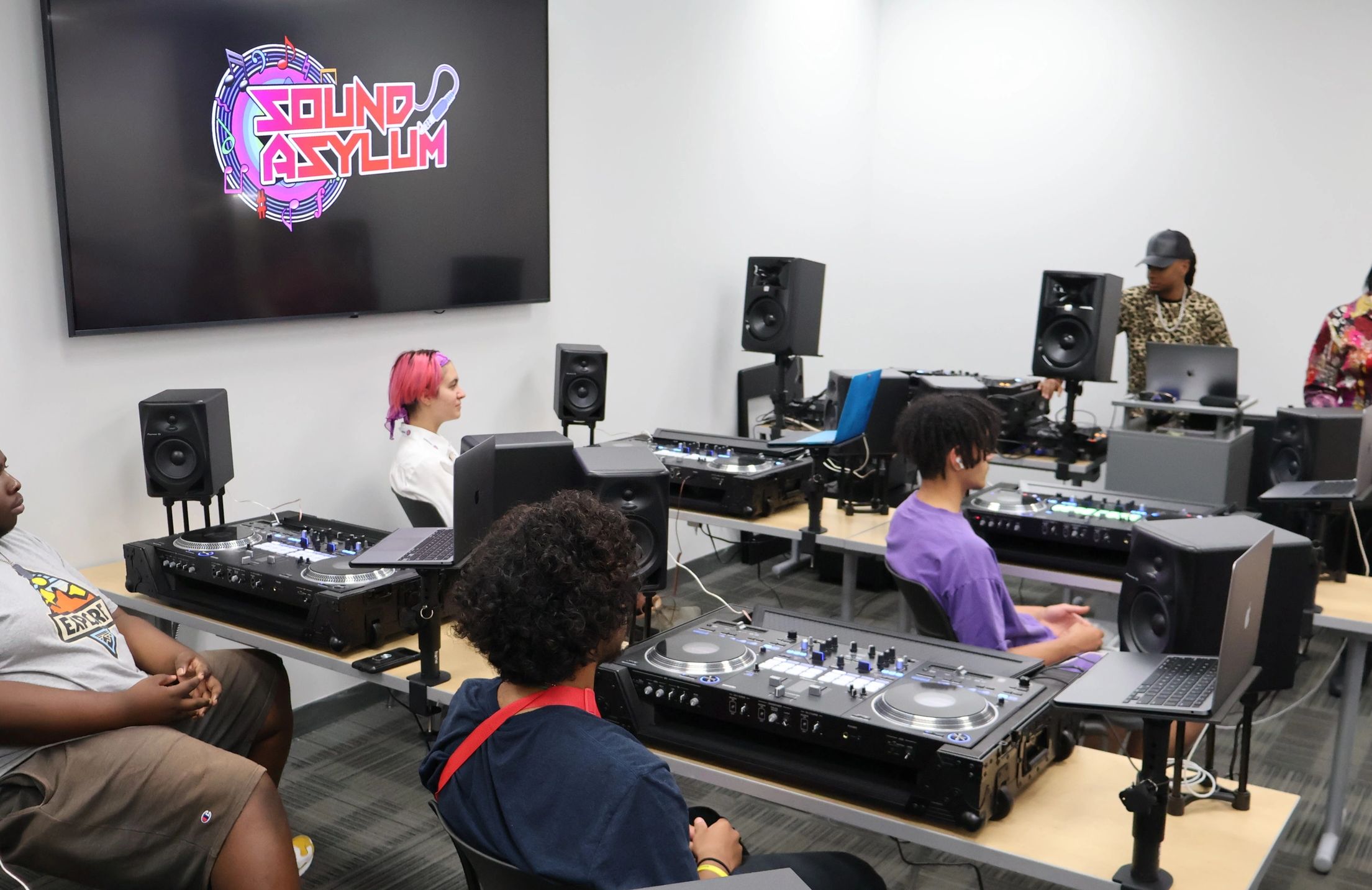 TMC students learning the "Art of DJing" from one of the world's best female DJ's, Paris Cesvette! 