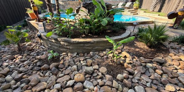 Backyard garden with pool and stone landscaping.