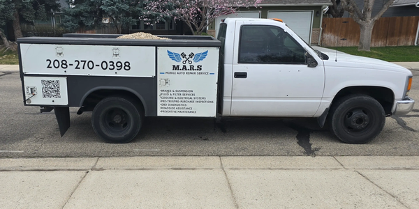 White mobile auto repair truck with M.A.R.S service logo and contact number.