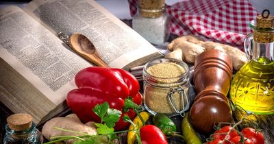 Photo of open cookbook and ingredients on a table.