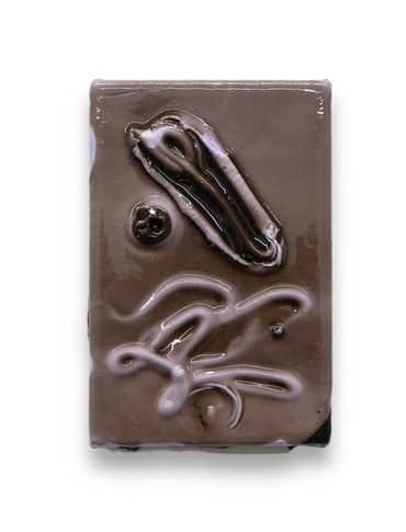 A rectangular chocolate bar with artistic swirls on top.