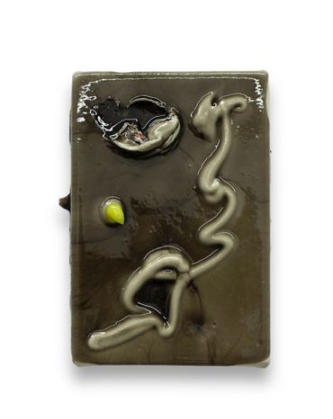 Glossy ceramic tile with abstract designs and a small yellow detail.