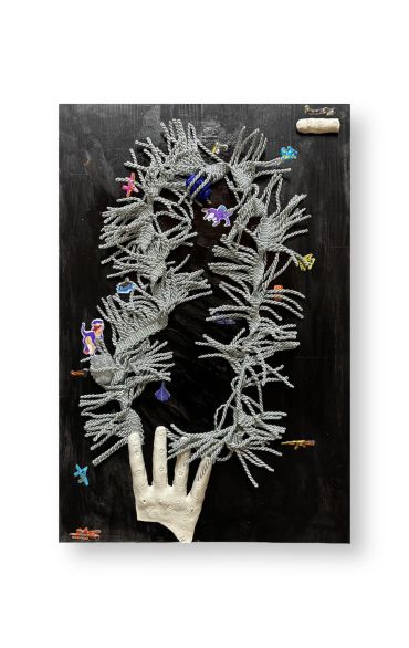 Artistic display of a hand and coral-like structure with colorful small figures on a black background.