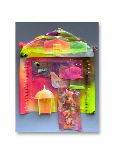 Colorful translucent plastic pieces arranged in a house-like shape on a blue background.