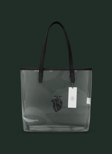 Transparent tote bag with black handles and a heart design on the front.