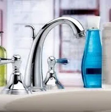 Bathroom sink with a faucet, blue soap bottle and hand wash bottle