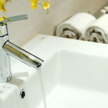 faucet sink and yellow flowers in the top left corner