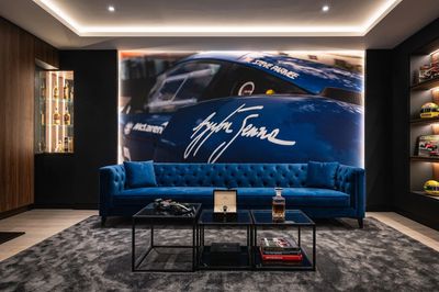 Stylish living room with a blue sofa and racing car mural.