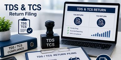 TDS and TCS return filing setup with stamps and laptop.