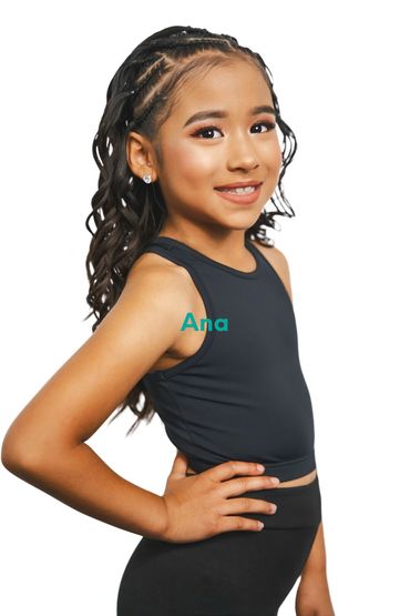 Young girl posing confidently in black athletic wear.