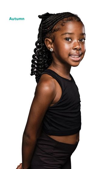 Young girl with braided hair posing in black outfit