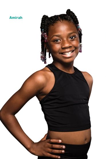 Smiling girl named Amirah in a black sleeveless top.
