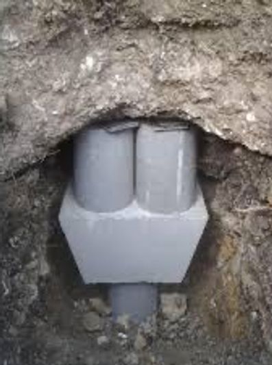 Pressed concrete piers are installed for slab foundation repair.