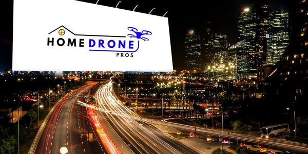 Billboard for Home Drone Pros over a busy city highway at night.