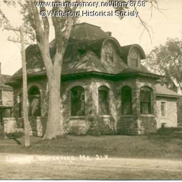 Historic house with curved roof windows and stone exterior.