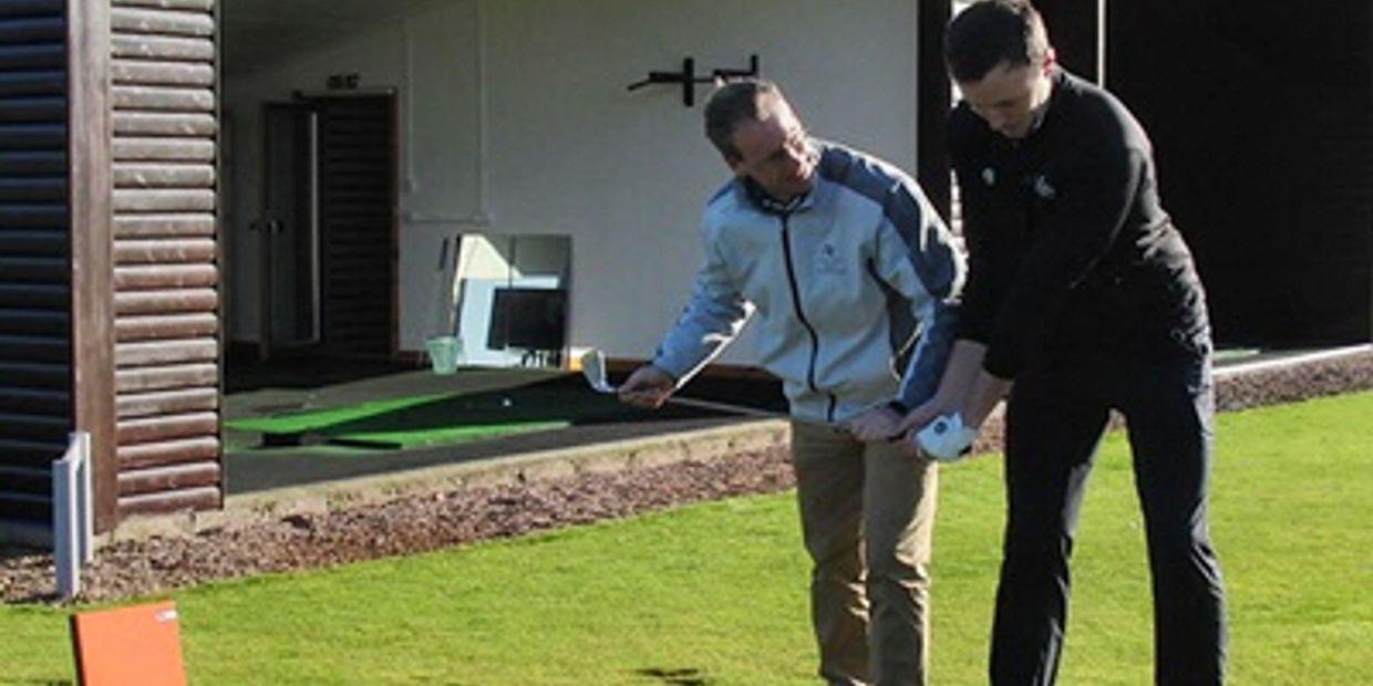 Golf coach Neil Marr teaching pro golfer Chris Robb.