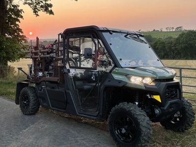 Agricarbon all-terrain vehicle parked up on a farm in front of a developing sunset.