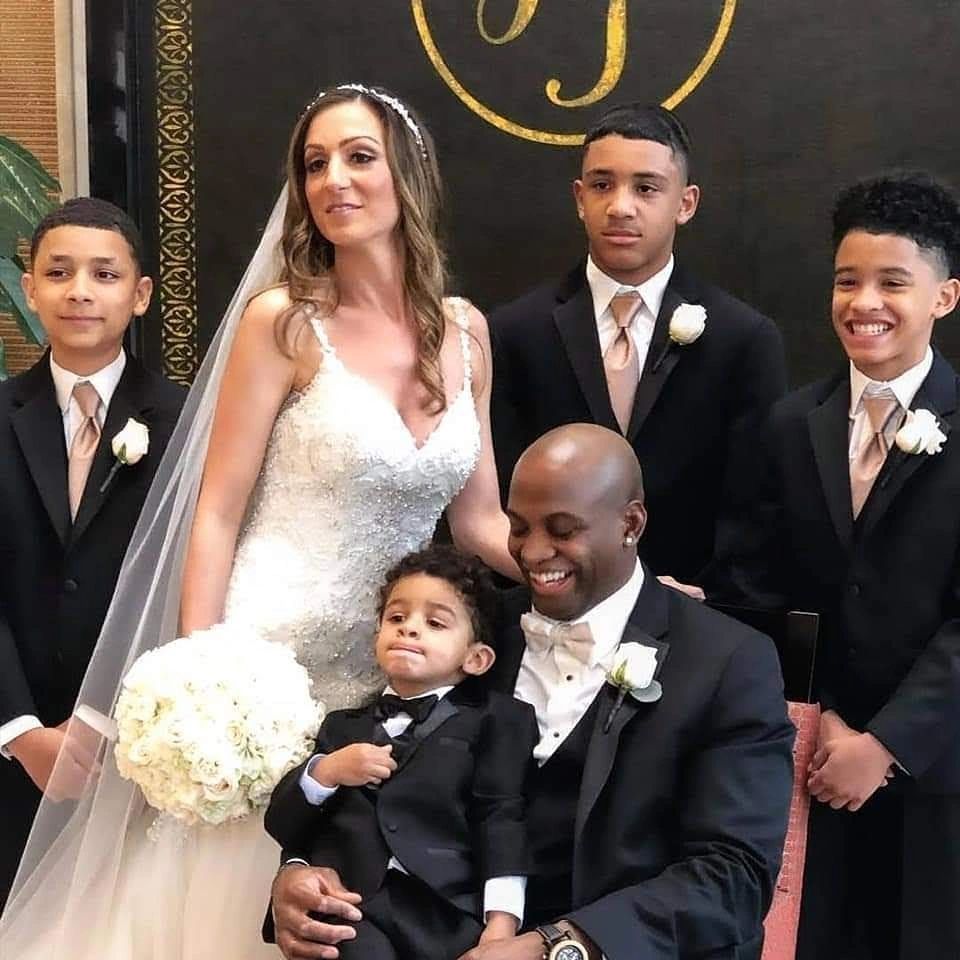 Wedding family portrait with bride, groom, and four boys.