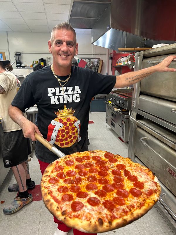 Uncle Frank with a fresh pizza
