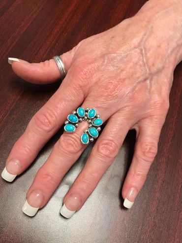 Kingman turquoise horseshoe ring accented with sterling balls and a split ring shank.