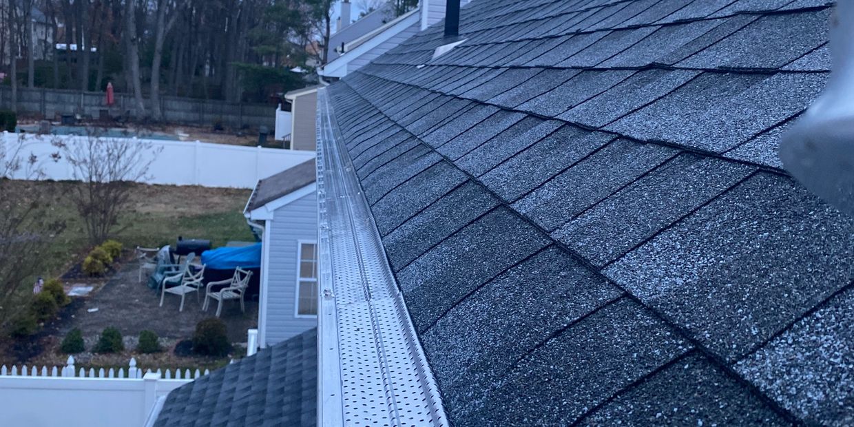 Close-up of a house roof and gutter system.