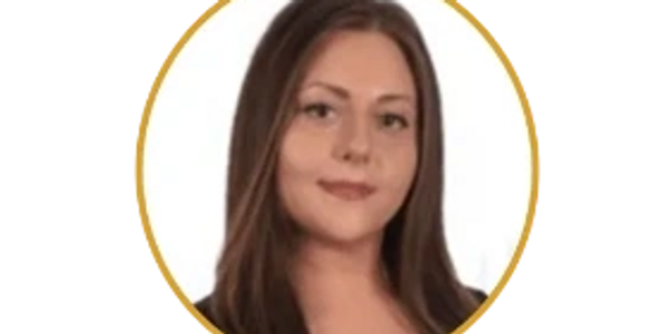 Portrait of a young woman with long brown hair, smiling gently.