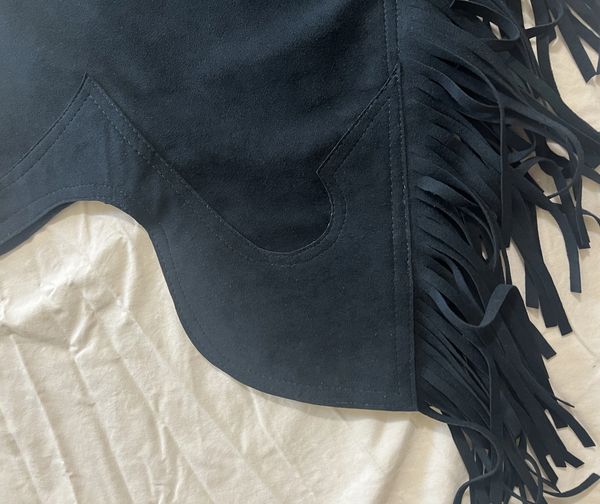 Black suede fabric with fringe detail.