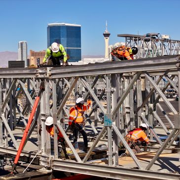 Aerowerx media photographing a construction site with a DJI Mavic 3 drone., 