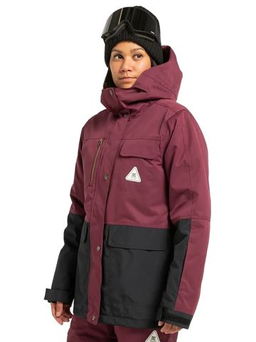 Woman in maroon and black winter jacket with goggles and beanie.